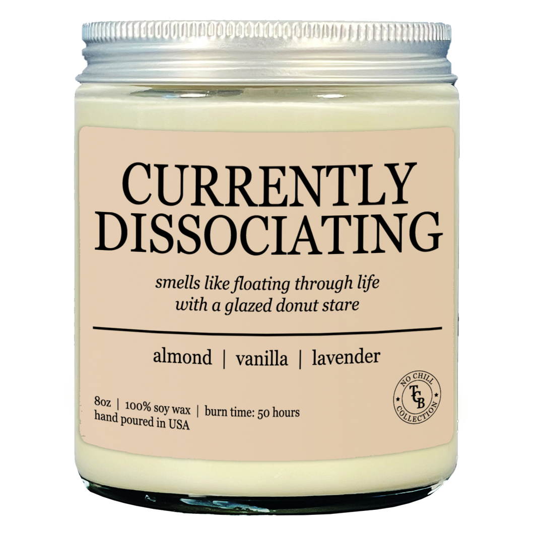Candle jar labeled 'Currently Dissociating' with description on a white background