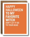 A greeting card with a bold orange background and white border, featuring the text 'HAPPY HALLOWEEN TO MY FAVORITE WITCH DON'T LET IT GO TO YOUR HEAD' in white uppercase letters. A brown kraft envelope is partially visible behind the card.