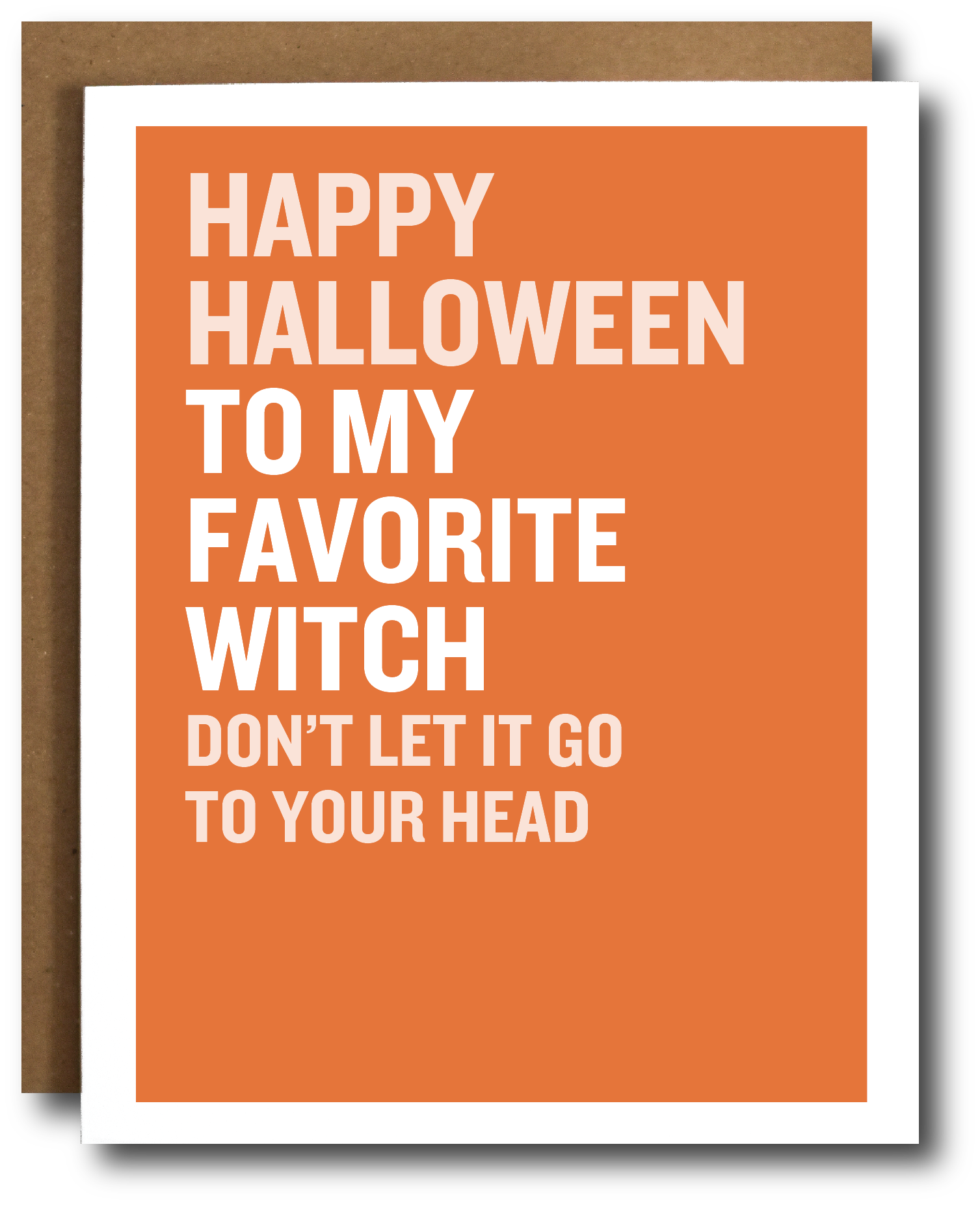 A greeting card with a bold orange background and white border, featuring the text 'HAPPY HALLOWEEN TO MY FAVORITE WITCH DON'T LET IT GO TO YOUR HEAD' in white uppercase letters. A brown kraft envelope is partially visible behind the card.