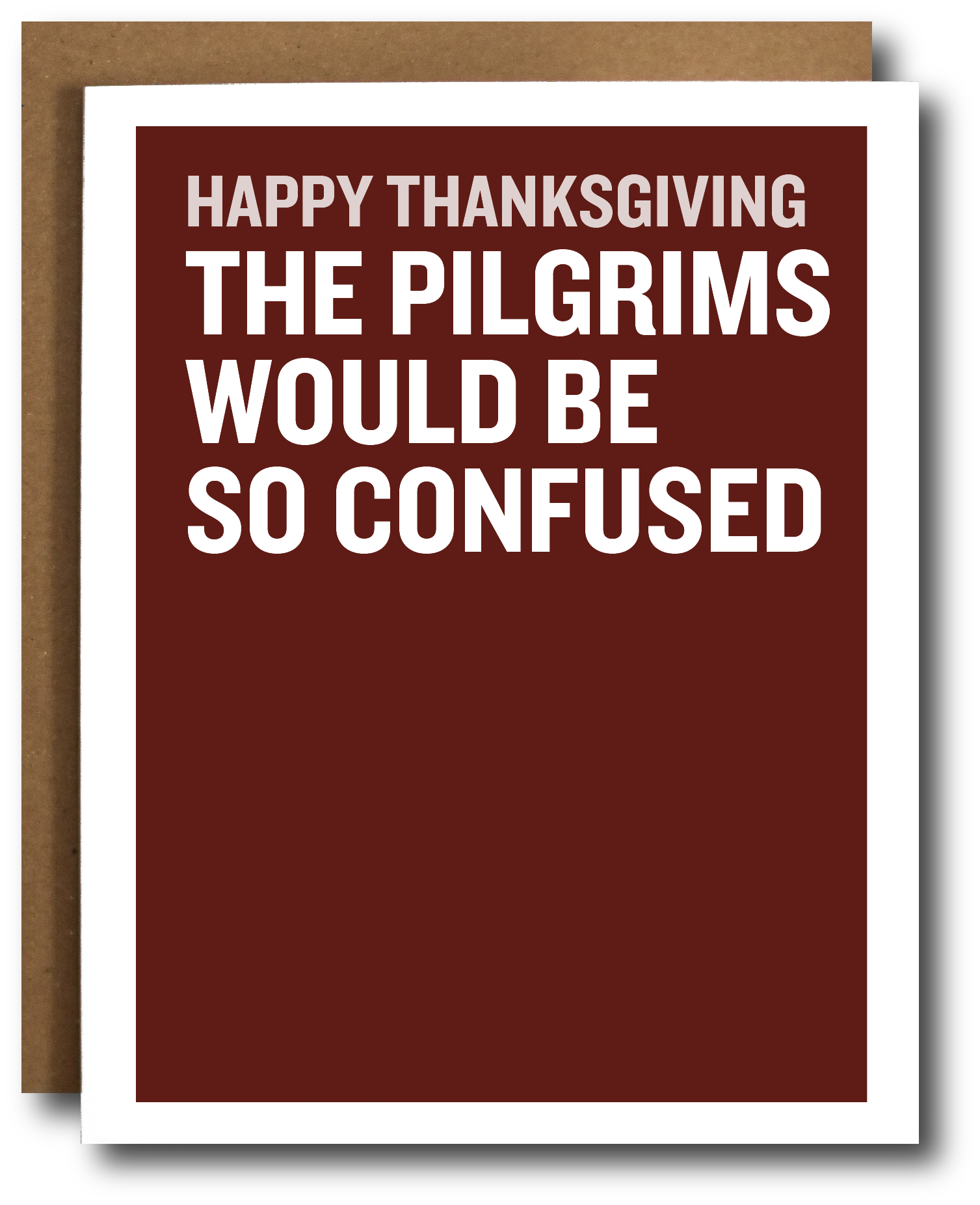 A Thanksgiving greeting card with a dark red background and bold white text reading 'HAPPY THANKSGIVING THE PILGRIMS WOULD BE SO CONFUSED,' shown with a brown envelope behind it on a white background.