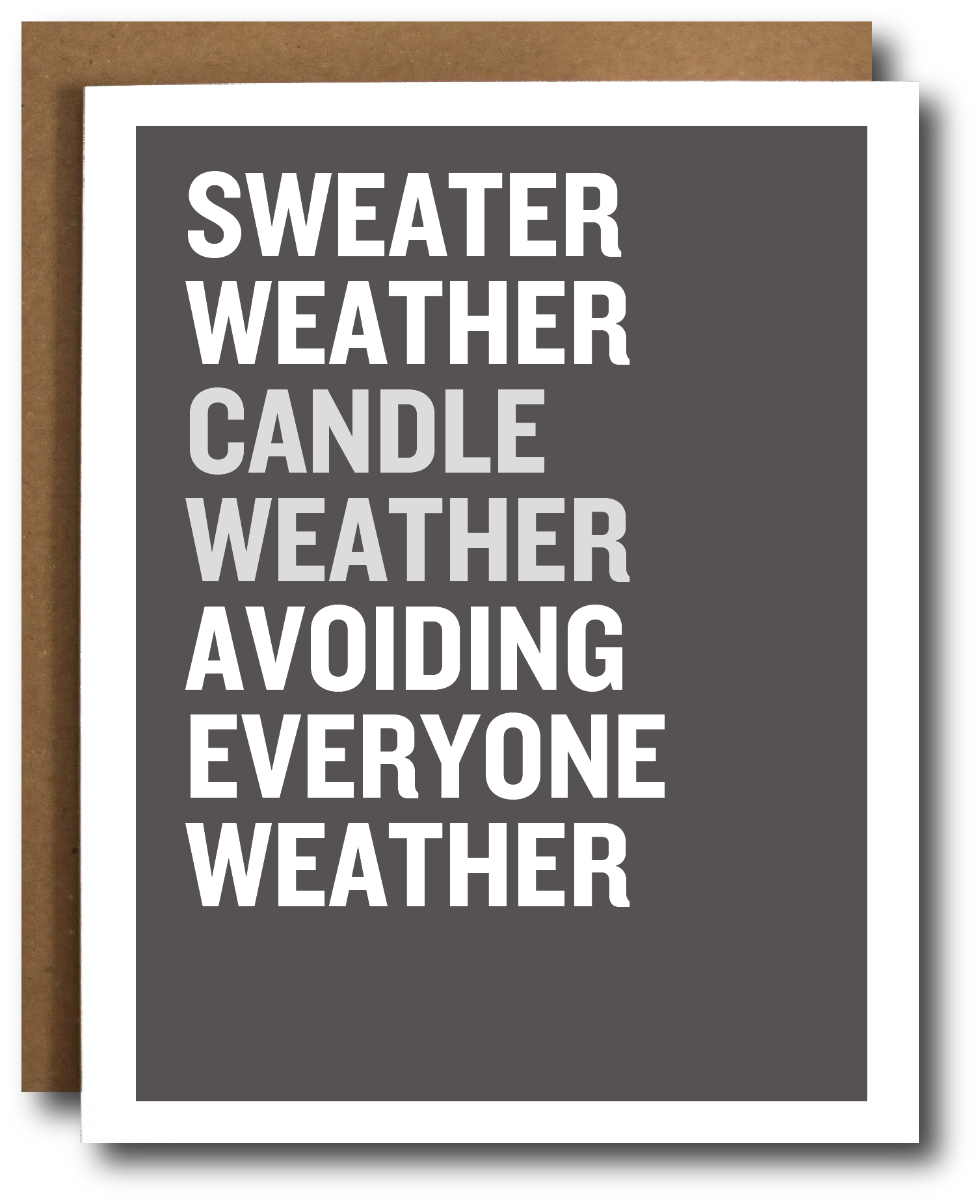 A greeting card with a dark gray face and bold white text reading 'SWEATER WEATHER CANDLE WEATHER AVOIDING EVERYONE WEATHER,' shown with a brown kraft envelope behind it on a white background.
