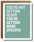 Card with humorous text 'You're not getting older, you're getting more specific' on a green background.