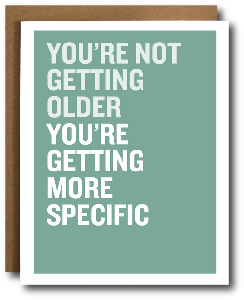 Card with humorous text 'You're not getting older, you're getting more specific' on a green background.
