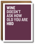 Greeting card with 'Wine doesn't ask how old you are HBD' text on a plum background