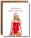 Holiday card featuring Taylor Swift in a red Santa suit holding a candy cane, with the text 'Wishing you a Merry Swiftmas' in festive font.