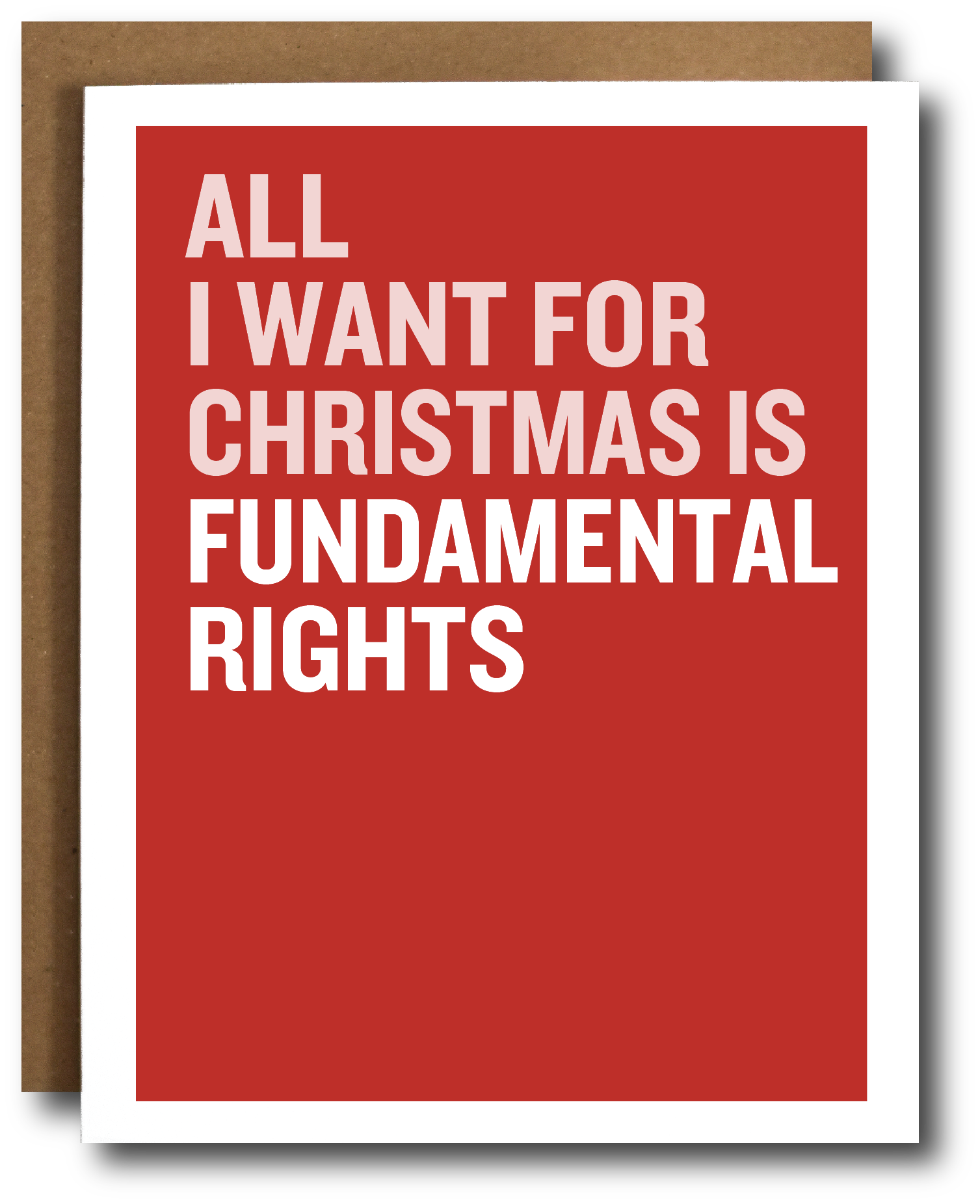 A greeting card with a bold red background and large white text reading 'ALL I WANT FOR CHRISTMAS IS FUNDAMENTAL RIGHTS,' shown with a brown kraft envelope behind it on a white background.