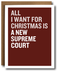 A greeting card with a dark red background and bold white text reading 'ALL I WANT FOR CHRISTMAS IS A NEW SUPREME COURT,' shown with a brown envelope behind it on a white background.