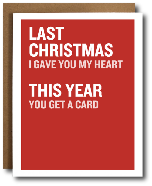 A red greeting card with white text reading 'LAST CHRISTMAS I GAVE YOU MY HEART THIS YEAR YOU GET A CARD', shown with a brown envelope behind it on a white background.