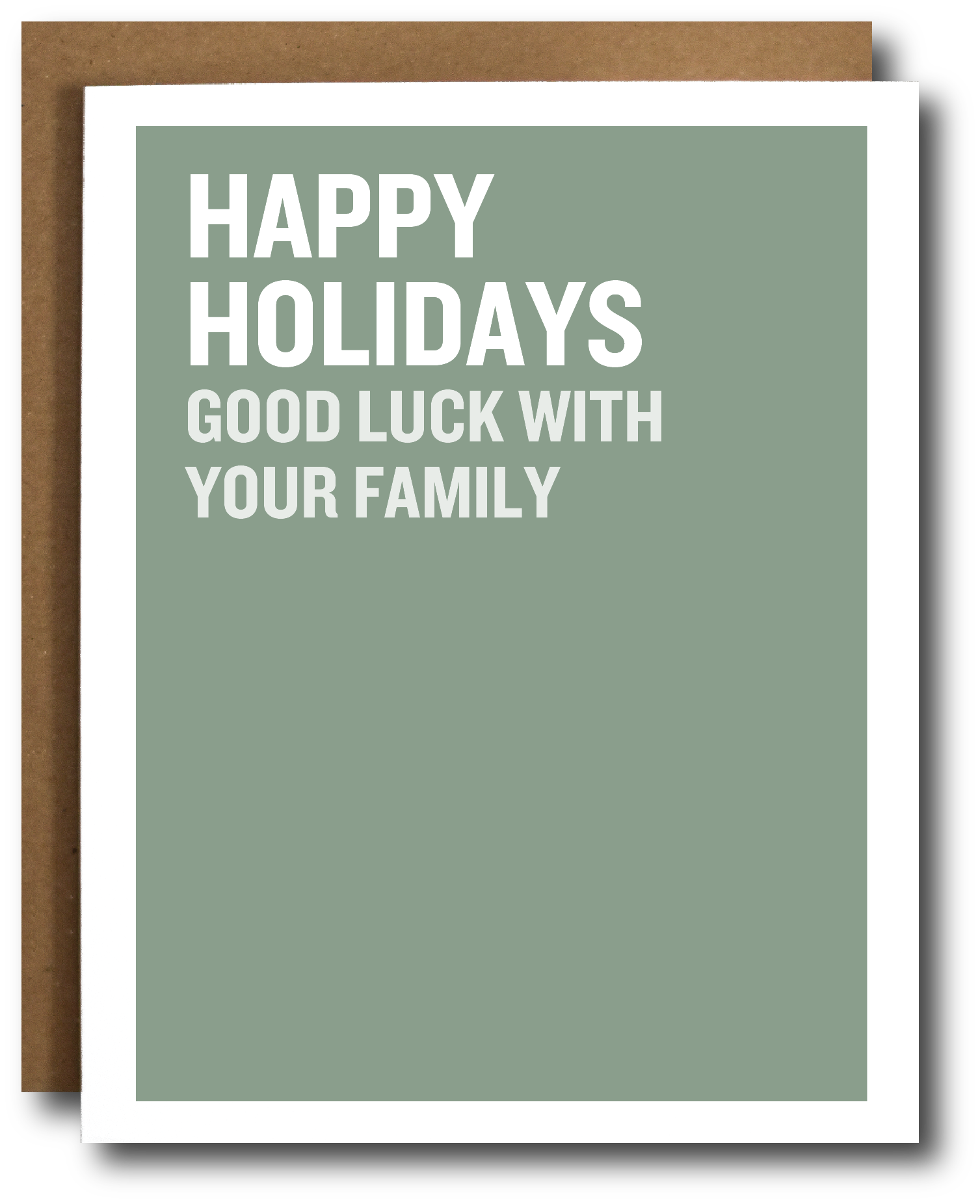 A holiday greeting card with a sage green background and bold white text reading 'HAPPY HOLIDAYS GOOD LUCK WITH YOUR FAMILY,' shown with a brown envelope behind it on a white background.