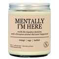 Candle that says "mentally im here" on the front